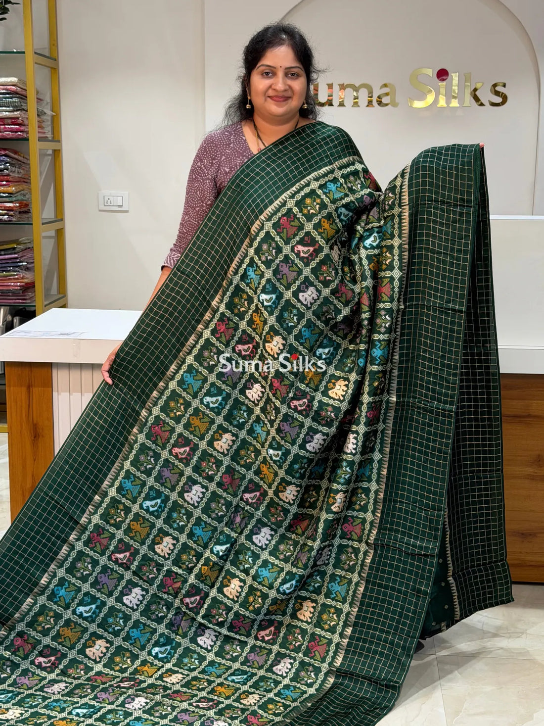 Moonga Crepe Patola Checks Border Saree Bottle Green Color